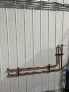 air controls plumbing pipes running across wall